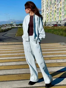 Casual autumn winter tracksuit set for women, featuring light blue zip jacket and pants.