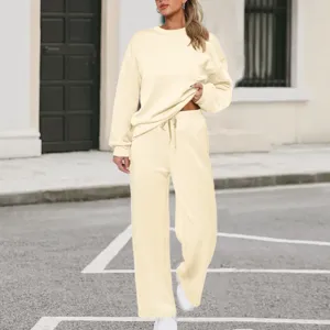 Beige knit two-piece sweatshirt set featuring a long-sleeve crewneck top and wide-leg pants.