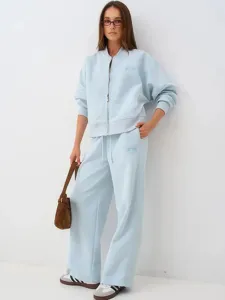 Detailed full-body view of women casual light blue tracksuit set with zip jacket and wide pants.