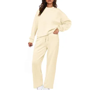 Detail view of women's beige long sleeve sweatshirt and wide leg pants lounge set knitwear.