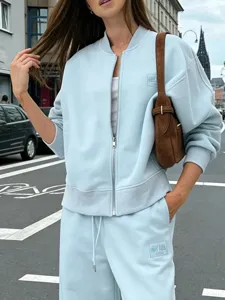 Women casual light blue zip-up sweatshirt jacket and matching pants autumn tracksuit set.