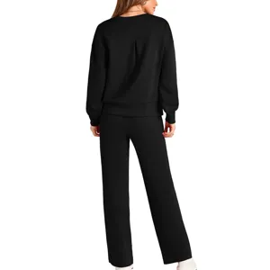 Detail view of women solid black long sleeve sweatshirt and wide leg pants lounge two piece set.