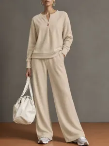 Detailed shot of the casual beige V-neck sweatshirt and wide-leg pants lounge set.