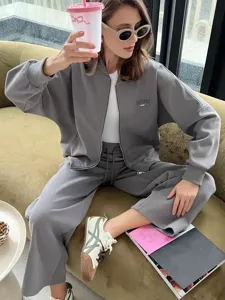 Detail view of women's casual grey zip hoodie and sweatpants set, cozy lifestyle shot.