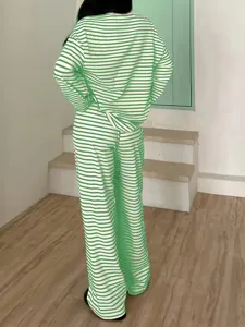 Detailed view of women green white striped long sleeve casual loungewear top and pants set.