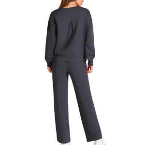 Back view of dark grey knit two-piece set, featuring long sleeve top and wide leg pants.