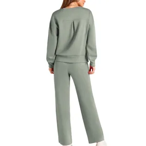 Back view of women knit two piece set, sage green long sleeve top and wide leg pants detail.