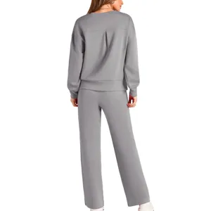 Back view of a casual women knit tracksuit featuring long sleeve top and wide leg pants.