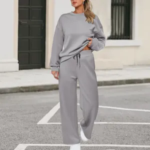 Casual grey knit two-piece tracksuit featuring long sleeve sweatshirt and wide leg pants.