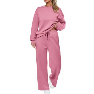 Women pink knit two-piece loungewear set, long sleeve crewneck top and wide leg pants.