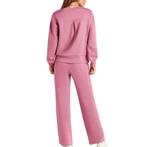 Detailed back view of women pink knit two piece set long sleeve top and wide leg pants.