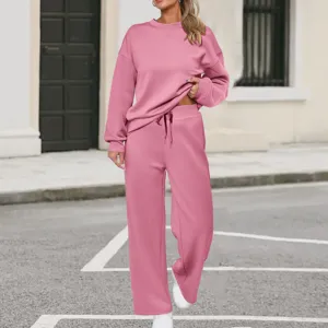 Detail view of pink long sleeve sweatshirt and wide leg pants two piece casual tracksuit set.