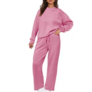 Detail view of the women pink knit two piece tracksuit with cozy sweatshirt and wide leg pants.