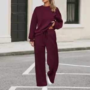Close-up street scene showcasing the stylish maroon sweatshirt and wide-leg trousers outfit.
