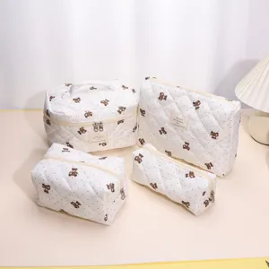 Quilted cosmetic bag set with cute bear pattern, large capacity portable travel organizer.