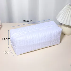 Detailed view of the white striped storage bag showing clear dimensions and zipper closure.