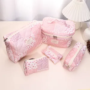 Pink quilted cosmetic bag set detail view, featuring charming floral and plaid patchwork design.