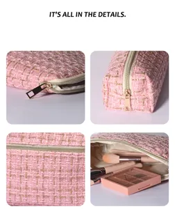 Pink tweed cosmetic bag detail showcasing fabric texture, gold zipper, and inner storage.