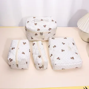 Quilted cosmetic bag set featuring cute bear pattern and polka dots for travel storage.