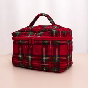 Quilted plaid makeup bag detail shot showing soft fabric texture, zipper closure and sturdy handle.