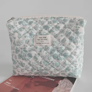 Quilted floral cosmetic bag, large capacity makeup pouch, portable padded storage organizer.