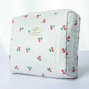 Quilted cosmetic bag with cherry print, large capacity portable makeup storage pouch for daily use.