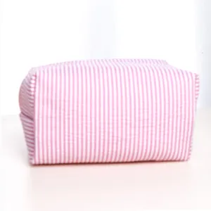 Pink and white striped travel cosmetic bag, portable toiletry organizer pouch for daily use.
