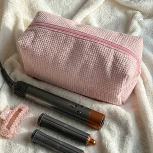 Pink waffle hair dryer storage bag and portable hair curler case organizer daily use