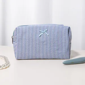Blue and white striped seersucker cosmetic bag with cute bow, large capacity travel makeup pouch.