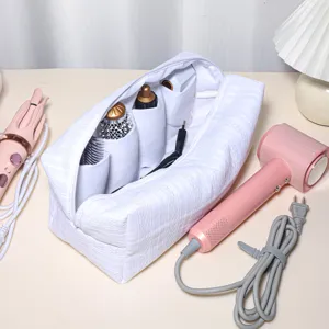 White quilted storage bag with multiple compartments for hair styling tools and accessories.
