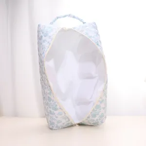 Quilted floral travel hair dryer and cosmetic storage bag, portable handheld design with zipper closure.