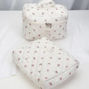 Quilted floral cosmetic travel storage bag set, cute grid design, portable makeup organizer.