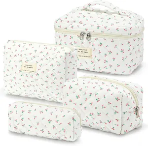 Quilted cherry cosmetic bag detail view, soft cotton storage pouch with smooth zipper and handle.