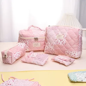 Quilted cosmetic bag set with pink plaid and floral pattern, portable travel makeup organizer pouch.