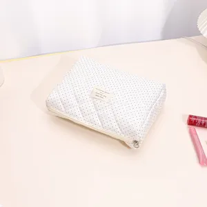 Quilted polka dot cosmetic bag large capacity portable makeup organizer for daily travel use.