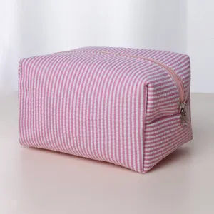 Pink white striped cosmetic bag detail view, portable zipper makeup pouch for travel and daily use.