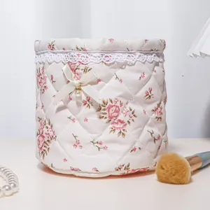 Floral quilted storage basket detail, cute bow and lace trim for desktop organization.