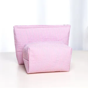 Pink striped cosmetic bag set detail, portable zipper storage pouch for travel toiletries.