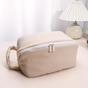 Minimalist solid color puffy makeup bag with large capacity, waterproof cosmetic storage pouch.