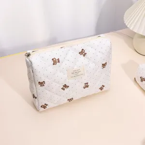 Detailed view of the quilted makeup bag featuring cute bear pattern and fabric label text.