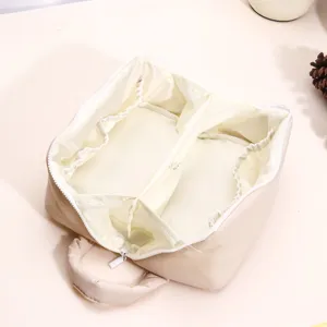 Puffy cosmetic bag detail showing large capacity waterproof multi-functional interior partitions.