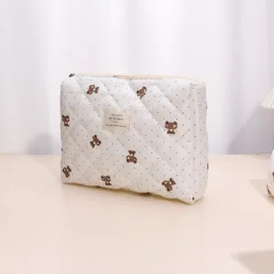 Detailed view of the quilted cosmetic pouch with cute bear prints and polka dot design.