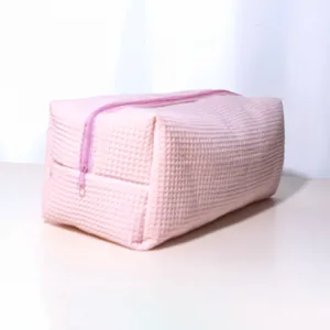 Pink waffle pattern storage bag detail showing textured fabric and smooth pink zipper design.