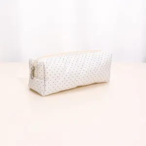White quilted makeup bag with black polka dots, portable zipper storage pouch for daily use.