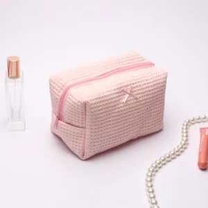 Pink waffle makeup bag, large capacity cosmetic travel pouch with cute bow design.