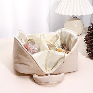 Minimalist solid color puffy cosmetic bag with large capacity, multi-functional partitioned storage.