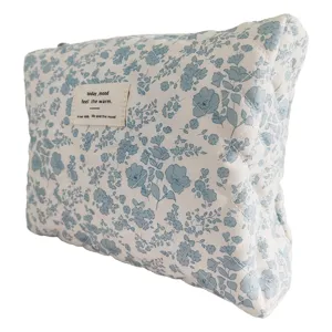 Blue floral quilted cosmetic bag, large capacity soft padded makeup storage pouch for daily use.