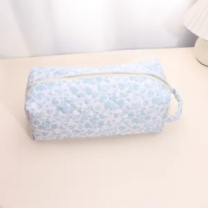 Detailed view of the quilted floral cosmetic bag, showing fine stitching and smooth zipper.