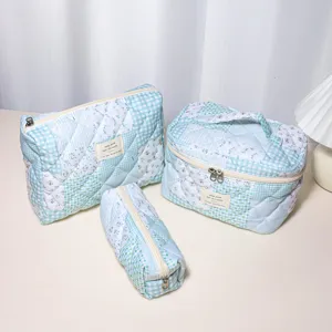 Quilted cosmetic bag set, blue plaid and floral padded makeup storage pouches for travel.