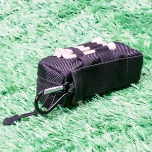 Golf tee storage pouch detail shot, black nylon accessory bag with carabiner hook and wooden tees.